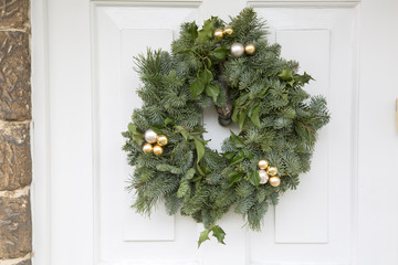 Green Leaf Christmas Wreath on Wooden Front Door