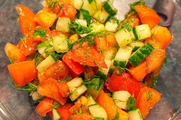 Fresh salad of cucumbers and tomato. Vegan food.
