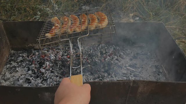 Grill grille and barbecue and mangala mesh. Preparation of sausage on a fire