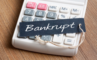 Bankrupt word written on label with calculator,Business Concept