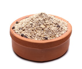 Oat flakes and power, instant oats with chocolate and quinoa seeds in clay bowl isolated on white background