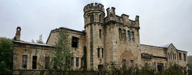 Old ruined abandoned castle in rainy autumn day