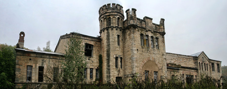 Old ruined abandoned castle in rainy autumn day