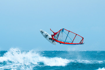 Windsurf jumps and fly out of the water