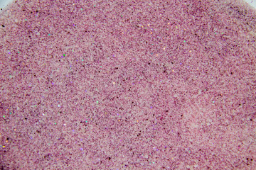 Fototapeta premium A painted sugar with glitter inside. Nice texture and background from sand with glitter. Colorful background