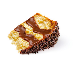 A slice of colomba pasquale, an Italian traditional Easter cake, with icing, filling and chocolate sprinkles on top. Read to use on a white backgroud.