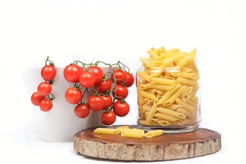  close-up of pasta and cherry tomatoes on a white background