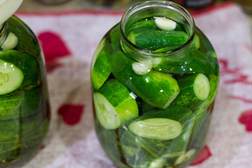 Pickles in jars for the winter. Preservation of vegetables. Environmentally friendly product. Delicious green cucumber. Selective focus. Lifestyle. The collection of vegetables. Canned food. The proce