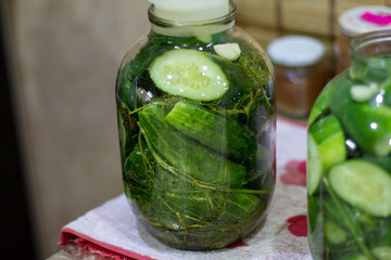 Pickles in jars for the winter. Preservation of vegetables. Environmentally friendly product. Delicious green cucumber. Lifestyle. The collection of vegetables. The process of cooking food