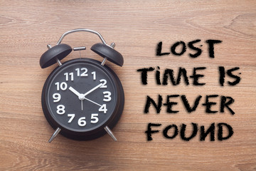 Lost time is never found -  inspirational advice handwriting with clock