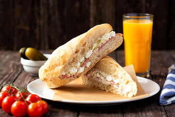 Tasty sandwiches with orange juice and vegetables