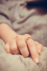 Beautiful ring with yellow sapphire on woman's hand, close-up.