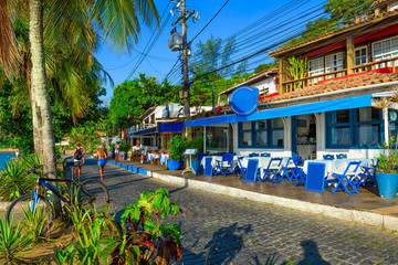 Seafront of Brigitte Bardot with palms and tables of restaurant in Buzios, Rio de Janeiro. Brazil. Cityscape of Buzios.