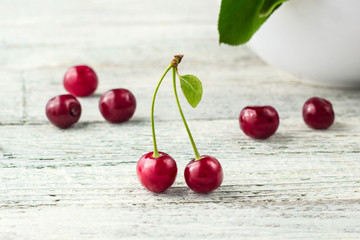 Two red cherry with leaf on a white background