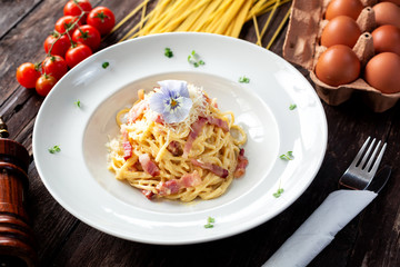 Pasta dish with chunks of meat decorated with flower on top