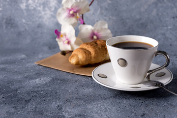 coffee cup and coffee beans on a gray background with space for your text