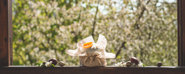 Happy Easter. Congratulatory easter background. Easter cake with easter eggs on a wooden window sill