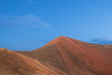 Beautiful red volcanic mountains and blue sky. Panoramic landscape.