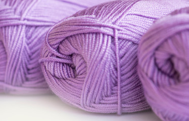 Close-up, knitting texture. Ball of violet thread knitting. 