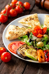 Delicious vegan snack with mix of grilled and fresh vegetables and grilled bread