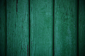Green emerald wood vertical planks, vintage old textured background with scratch marks and knots.