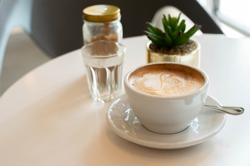 a cup of coffee on table