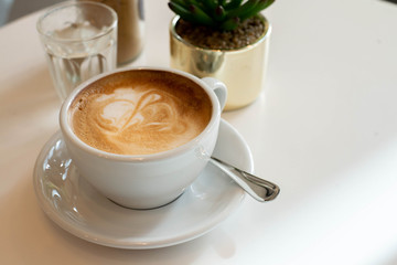 a cup of coffee on table