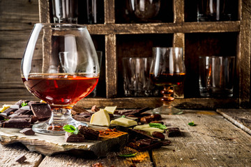 Strong alcohol drink. Glass of brandy, whiskey or cognac on the wooden table