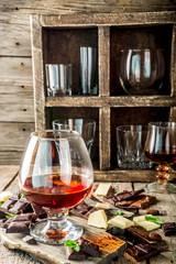 Strong alcohol drink. Glass of brandy, whiskey or cognac on the wooden table