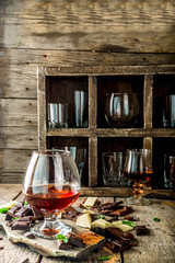 Strong alcohol drink. Glass of brandy, whiskey or cognac on the wooden table