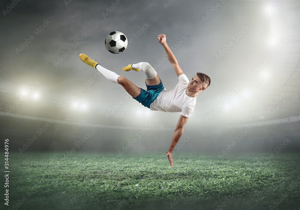 Wall mural Soccer player on a football field in dynamic action at summer da