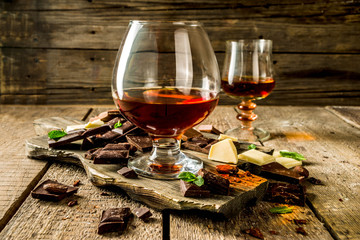 Strong alcohol drink. Glass of brandy, whiskey or cognac on the wooden table
