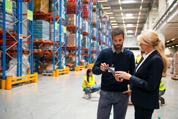 Managers in Warehouse discuss about business