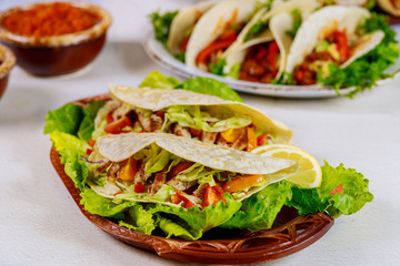 Delicious soft tortillas with salad and meat. Mexican cuisine.