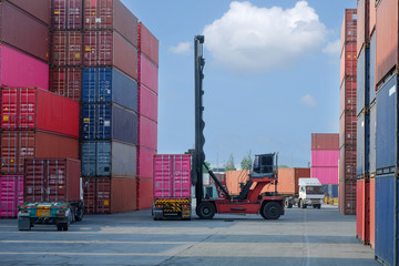 Container handlers are loading containers into trucks.