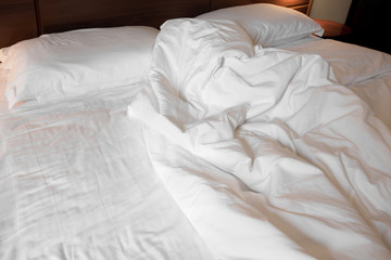 Fototapeta na wymiar Unmade bed in a hotel room