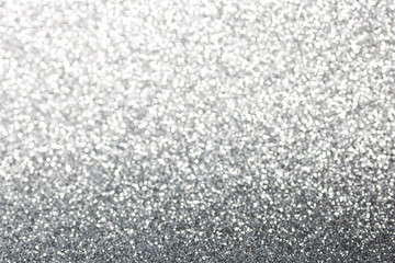 Metallic foil background. Shiny metal silver foil texture abstract defocused background. Sparkle glitter texture with bokeh lights