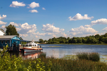 Fototapeta na wymiar The Golden ring of Russia. Sunny summer day in Yaroslavl. Bank of the Kotorosl river. Boats on the river