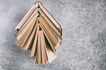Stack of old books on textural background