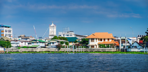 Old Chao Phraya River Thai traditional houses, village riverfront in Bangkok Thailand.