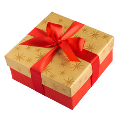 Red gift or present box with golden colored top and red ribbon bow isolated on white background