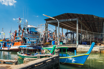 Fototapeta na wymiar Thai traditional fishing boats docked to Khura Buri Pier in Khura Buri District, Phang-nga, Thailand