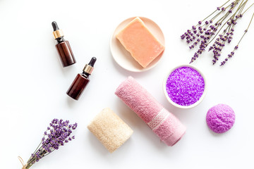 Fototapeta na wymiar Lavender spa set. Violet bath salt, soap, essence oil on white background top-down