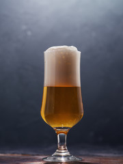 Glass of beer lager on a dark background