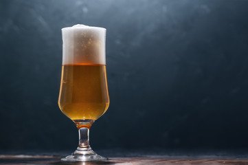 Glass of beer lager on a dark background