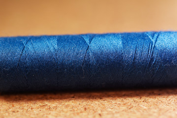 spools of thread on wooden background