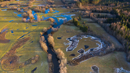 Aerial view to the semi-natural river floodplain landscape with the complex riparian habitats with the river bends and oxbows in Soomaa national park, Estonia