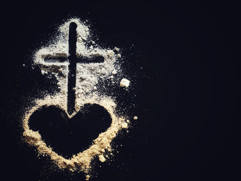 Lent Season,Holy Week and Good Friday concepts - Image of ash in shape of heart and cross on dark background