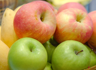 Red apples and green apples sale on the market or in the supermarket. Picking Fresh apples for Healthy food.