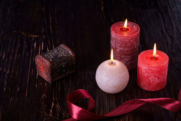 Three wax flame candlelight with little casket chest box in dark romantic light, love dating, Valentine's day, selective focus
